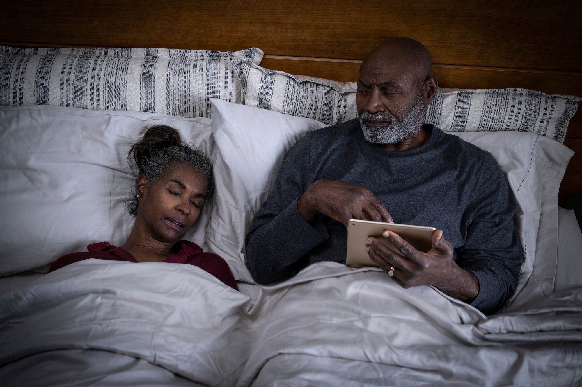 Man unable to sleep next to woman in bed