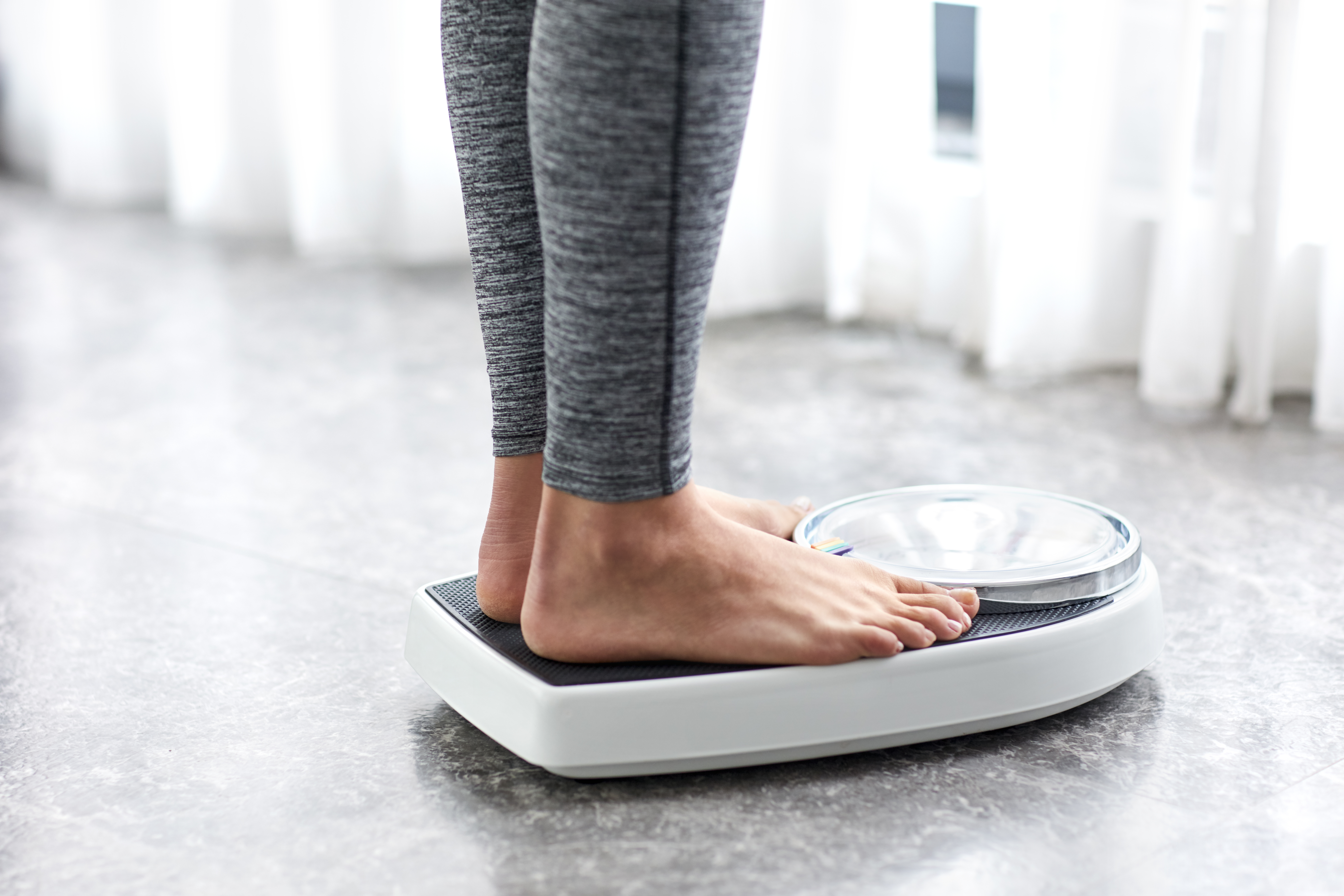 Woman stands on a scale